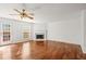 Cozy living room featuring hardwood floors, a fireplace, and a ceiling fan at 4740 Union Hill Rd, Canton, GA 30115