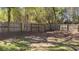 Wide backyard features a wood fence, grass, and trees at 1655 Cherry Hill Sw Rd, Conyers, GA 30094