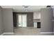 Open-concept area with light-colored flooring, a sliding glass door, and neutral wall paint at 1655 Cherry Hill Sw Rd, Conyers, GA 30094
