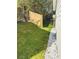 Side yard features new grass, a fence, and decorative rock at 1655 Cherry Hill Sw Rd, Conyers, GA 30094