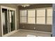 This sunroom features bright windows, neutral paint, sliding doors, and tile flooring at 1655 Cherry Hill Sw Rd, Conyers, GA 30094