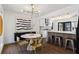 Stylish dining room with modern light fixture, statement art, and bar-top seating into the kitchen at 1970 Furlong Run, Lawrenceville, GA 30043