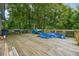 Large wooden back deck overlooks lush greenery, perfect for outdoor entertaining and relaxation at 2415 Wales Dr, Austell, GA 30106