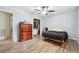 This bedroom features wood-look floors, a wood dresser, and an adjacent closet with hanging clothes at 2415 Wales Dr, Austell, GA 30106