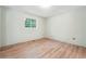 This bedroom offers wood flooring, a window with natural light, and neutral-colored walls at 2415 Wales Dr, Austell, GA 30106
