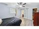 Cozy bedroom features a ceiling fan, ensuite bathroom, a closet, and light grey wood-look flooring at 2415 Wales Dr, Austell, GA 30106