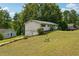 Expansive lot with a two-story home offering a basement garage with natural light and landscaping at 2415 Wales Dr, Austell, GA 30106