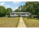 Inviting single-level home with a traditional design, surrounded by lush landscaping and mature trees at 2415 Wales Dr, Austell, GA 30106