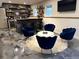 Basement seating area with unique polished concrete floors, blue club chairs and shag rug at 410 Spring Lake Hls, Canton, GA 30114