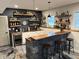 Basement wet bar with black brick, wooden countertop, shelving and polished concrete floor at 410 Spring Lake Hls, Canton, GA 30114