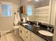 Bright bathroom features double sinks, granite countertops, decorative cabinets, and framed mirror at 410 Spring Lake Hls, Canton, GA 30114