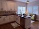 Modern kitchen featuring white cabinets, a black countertop, and stainless steel appliances at 410 Spring Lake Hls, Canton, GA 30114