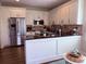 Bright kitchen with stainless steel fridge, white cabinets, backsplash, and black countertops at 410 Spring Lake Hls, Canton, GA 30114