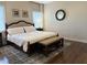 Bedroom with bed, neutral colored walls, side tables, lamps, and light from window at 410 Spring Lake Hls, Canton, GA 30114