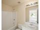 This bathroom features a shower-tub combo, neutral color scheme, and traditional fixtures at 63 Shadowhill Ct, Loganville, GA 30052