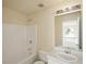 This bathroom features a shower-tub combo, neutral color scheme, and traditional fixtures at 63 Shadowhill Ct, Loganville, GA 30052