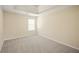 Neutral bedroom features plush carpeting, a window with blinds, and fresh paint at 63 Shadowhill Ct, Loganville, GA 30052