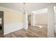 Elegant dining room with hardwood floors and decorative wainscoting and trim at 63 Shadowhill Ct, Loganville, GA 30052