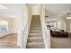 Entryway with stairway and hardwood flooring and adjoining dining and living area at 63 Shadowhill Ct, Loganville, GA 30052