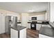 Well-appointed kitchen with white cabinetry, modern appliances, and an island for prep space at 63 Shadowhill Ct, Loganville, GA 30052
