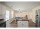 Bright kitchen with white cabinets, dark countertops, and stainless steel appliances at 63 Shadowhill Ct, Loganville, GA 30052