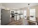 Functional kitchen with bright cabinetry, matching appliances, and dining area at 63 Shadowhill Ct, Loganville, GA 30052