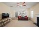 Open-concept living room with neutral tones, a cozy fireplace, and a staircase at 63 Shadowhill Ct, Loganville, GA 30052