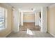Spacious living room features plush carpeting, white pillars, fresh paint, and lots of natural light at 63 Shadowhill Ct, Loganville, GA 30052