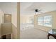 Upstairs loft area with a ceiling fan and window for natural light at 63 Shadowhill Ct, Loganville, GA 30052