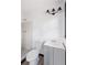 Bathroom features a modern vanity, toilet, shower, and updated lighting fixtures at 1463 Rockmoor Ct, Stone Mountain, GA 30088