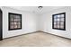 Bright bedroom features neutral carpet, white walls, and dark trim around two windows providing ample natural light at 1463 Rockmoor Ct, Stone Mountain, GA 30088
