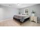 Relaxing bedroom featuring neutral tones, tiled floor, and a side table at 3776 Bromolow Trl, Lawrenceville, GA 30044