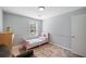 Cozy bedroom with natural light, decorative rug, and neutral color scheme at 3776 Bromolow Trl, Lawrenceville, GA 30044