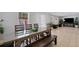 Open-concept dining area with tiled flooring seamlessly flowing into an adjacent living space with a large table at 3776 Bromolow Trl, Lawrenceville, GA 30044