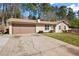 Charming single-story home with a well-manicured lawn, stone accents, and an attached two-car garage at 3776 Bromolow Trl, Lawrenceville, GA 30044