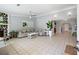 Spacious living room featuring tiled flooring, a stone fireplace, and neutral gray walls for a modern aesthetic at 3776 Bromolow Trl, Lawrenceville, GA 30044