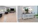 Spacious open-concept living space with tiled flooring, seamlessly connecting sitting and dining areas at 3776 Bromolow Trl, Lawrenceville, GA 30044