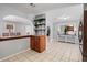 Open living space showcasing the connection between kitchen, dining, and living areas with tiled floors at 3776 Bromolow Trl, Lawrenceville, GA 30044