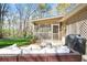 Relaxing outdoor patio area with comfortable seating and views of the wooded yard at 5095 Derry Nw Rd, Acworth, GA 30101