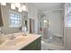 Modern bathroom with subway tile shower, glass door, and a vanity with stylish fixtures at 5095 Derry Nw Rd, Acworth, GA 30101