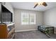 Cozy bedroom with a ceiling fan, natural light, and furniture at 5095 Derry Nw Rd, Acworth, GA 30101