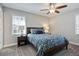 Cozy bedroom featuring a ceiling fan, bedside table, and floral bedding that adds a splash of color at 5095 Derry Nw Rd, Acworth, GA 30101