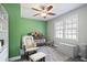 Charming Bedroom with a crib, rocking chair, and bright green accent wall at 5095 Derry Nw Rd, Acworth, GA 30101