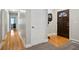 Hallway with hardwood floors leading to the front door and other rooms at 5095 Derry Nw Rd, Acworth, GA 30101