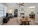 Inviting living room with neutral paint, plush carpet, a cozy fireplace, and ample natural light from the large window at 5095 Derry Nw Rd, Acworth, GA 30101