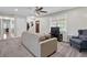 Inviting living room with neutral tones, ceiling fan, and a cozy armchair near the window at 5095 Derry Nw Rd, Acworth, GA 30101
