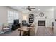 Cozy living room featuring neutral paint, plush carpet, a fireplace, large window and modern furniture at 5095 Derry Nw Rd, Acworth, GA 30101