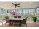 Inviting screened patio with dining area, ceiling fan, and serene wooded view for outdoor enjoyment at 5095 Derry Nw Rd, Acworth, GA 30101