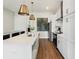 Modern kitchen with quartz countertops, stainless steel appliances, and stylish pendant lights at 921 Hughley Circle Se # 66, Atlanta, GA 30316