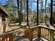 View of the backyard with mature trees, from a raised wooden deck at 9364 Woodloop Ct, Jonesboro, GA 30238